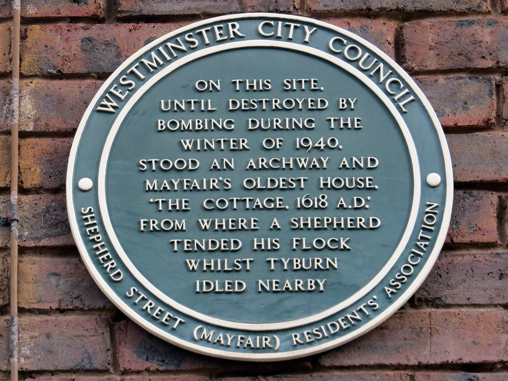 Westminster City Council plaque by Shepherd Street (Mayfair) Residents Association commemorating Mayfair's old house "The Cottage" from where a shepherd tended his flock whilst Tyburn idled nearby